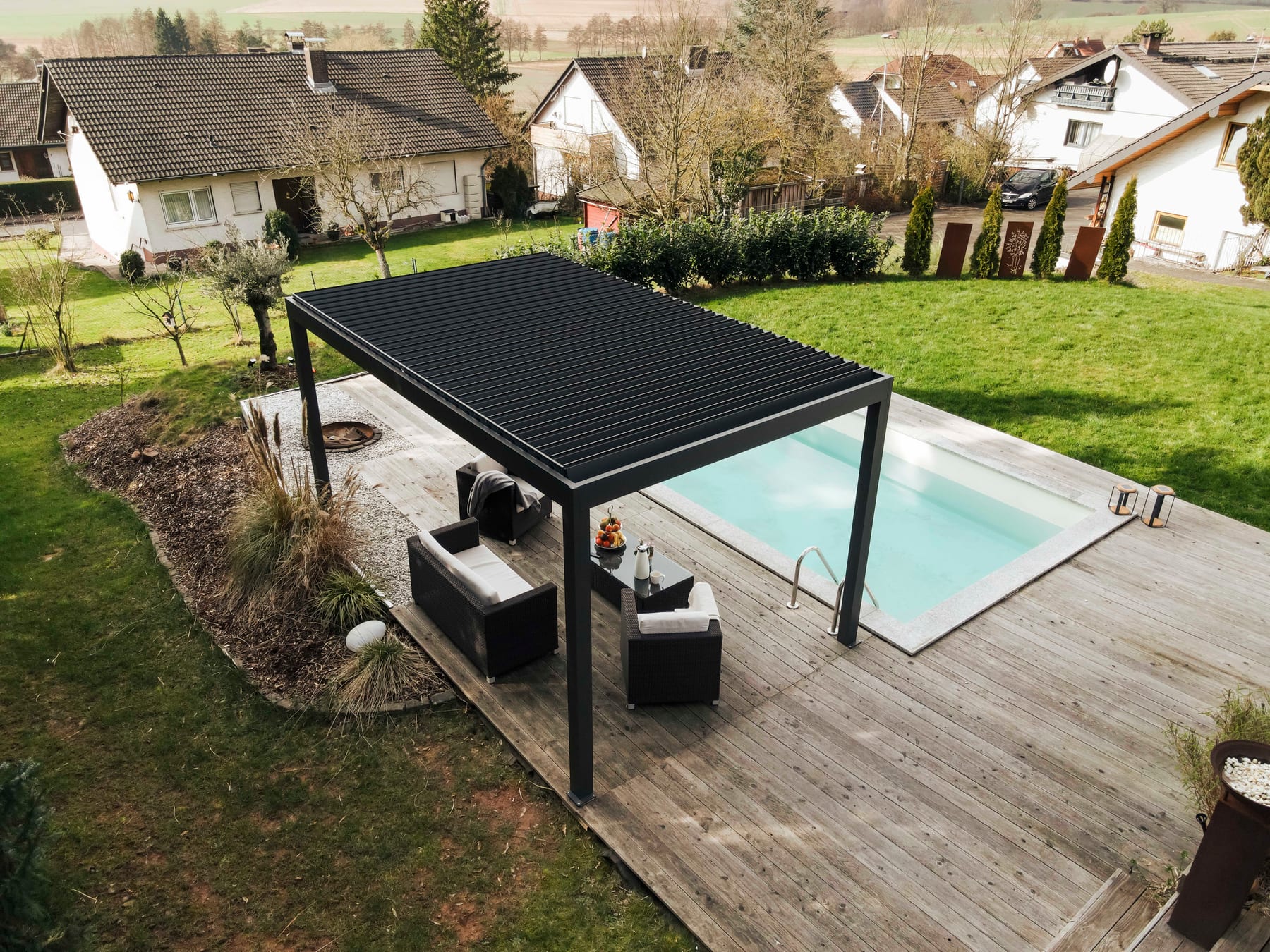 Aerial view of a UK semi-detached garden with a 4 x 3 metre aluminium pergola positioned near the house, showing lawn space remaining