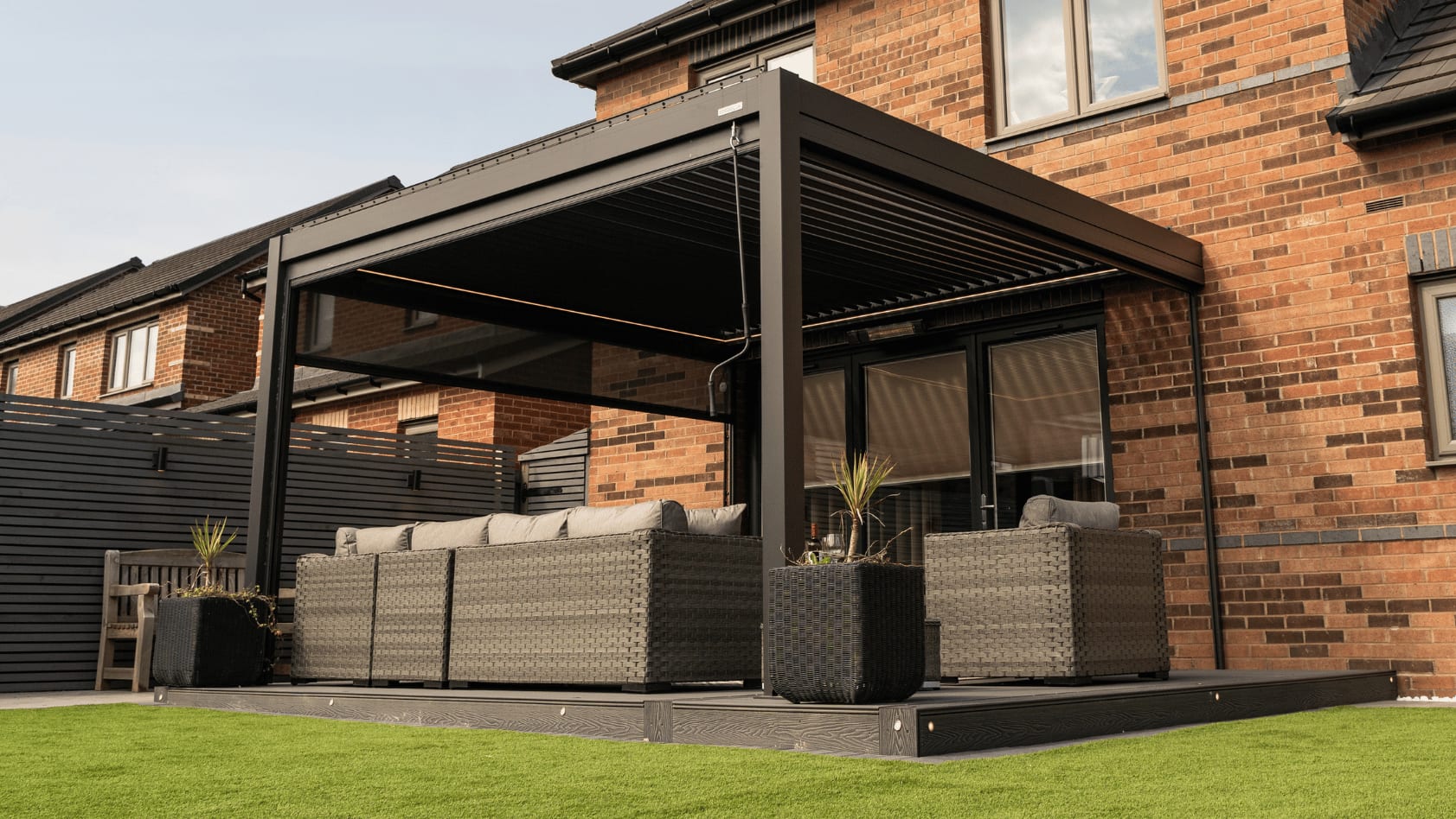 Side-by-side UK garden scenes showing a manually operated Pergola 4 on a small patio and a motorised Pergola 4 Pro on a mid-size terrace