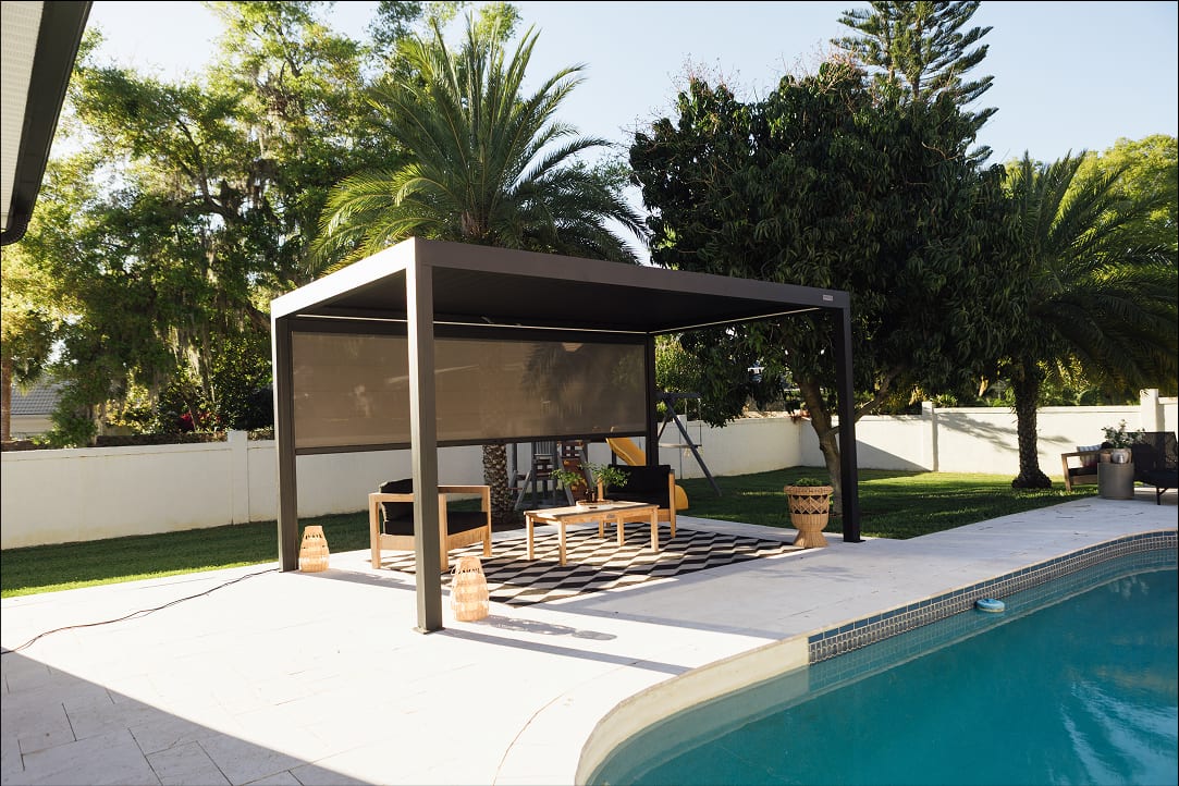 Terrasse bois composite avec socles ballastés sous poteaux de pergola aluminium gris anthracite, vue de côté avant installation des lames