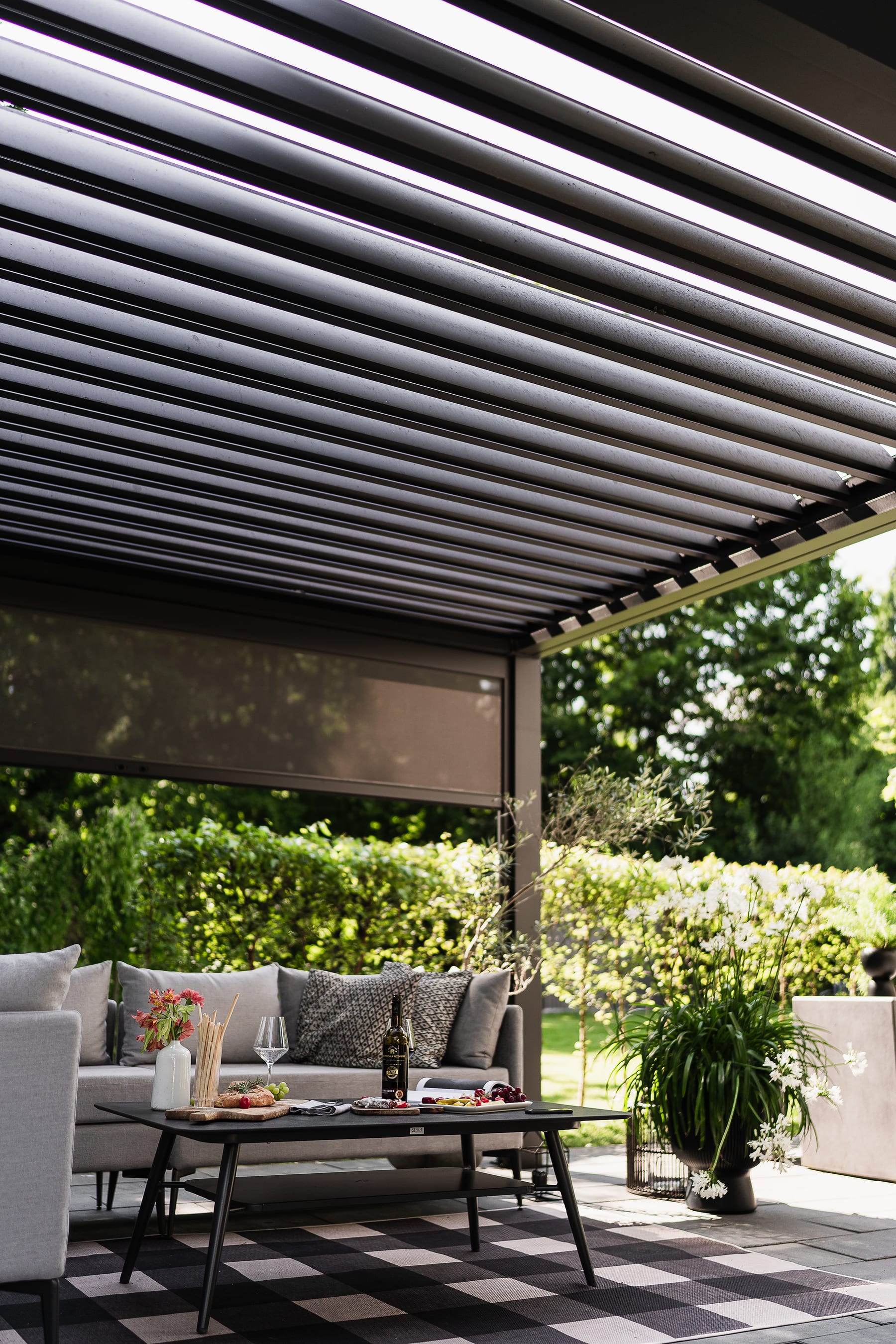Pergola with louvres open and screen partially pulled down